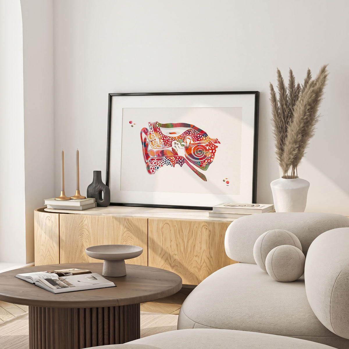 Framed ear cross-section watercolor print in a warm living room