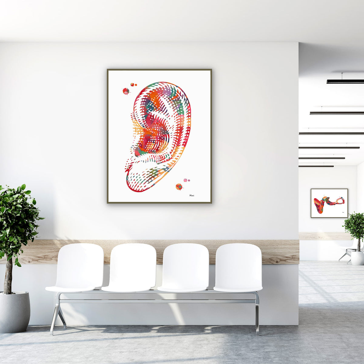 Framed human ear anatomy watercolor print in a clinic waiting room