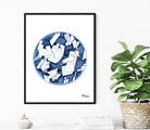 Framed Cholesterol Crystals Print with blue and white design on a wall with a plant and decor items.