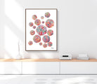 Framed science art print on a wall above a wooden shelf.