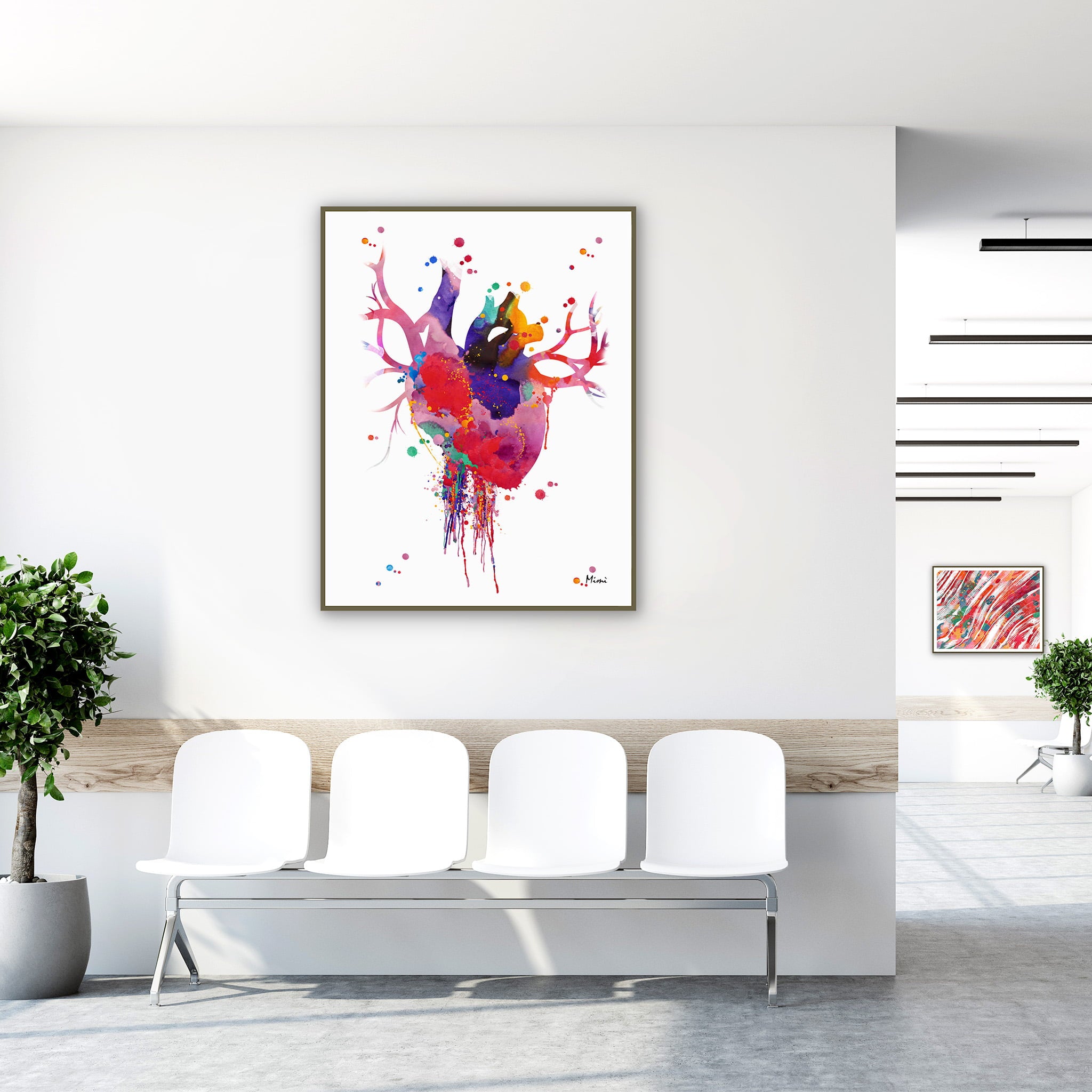 Framed bold modern anatomical heart watercolor print in a clinic waiting room