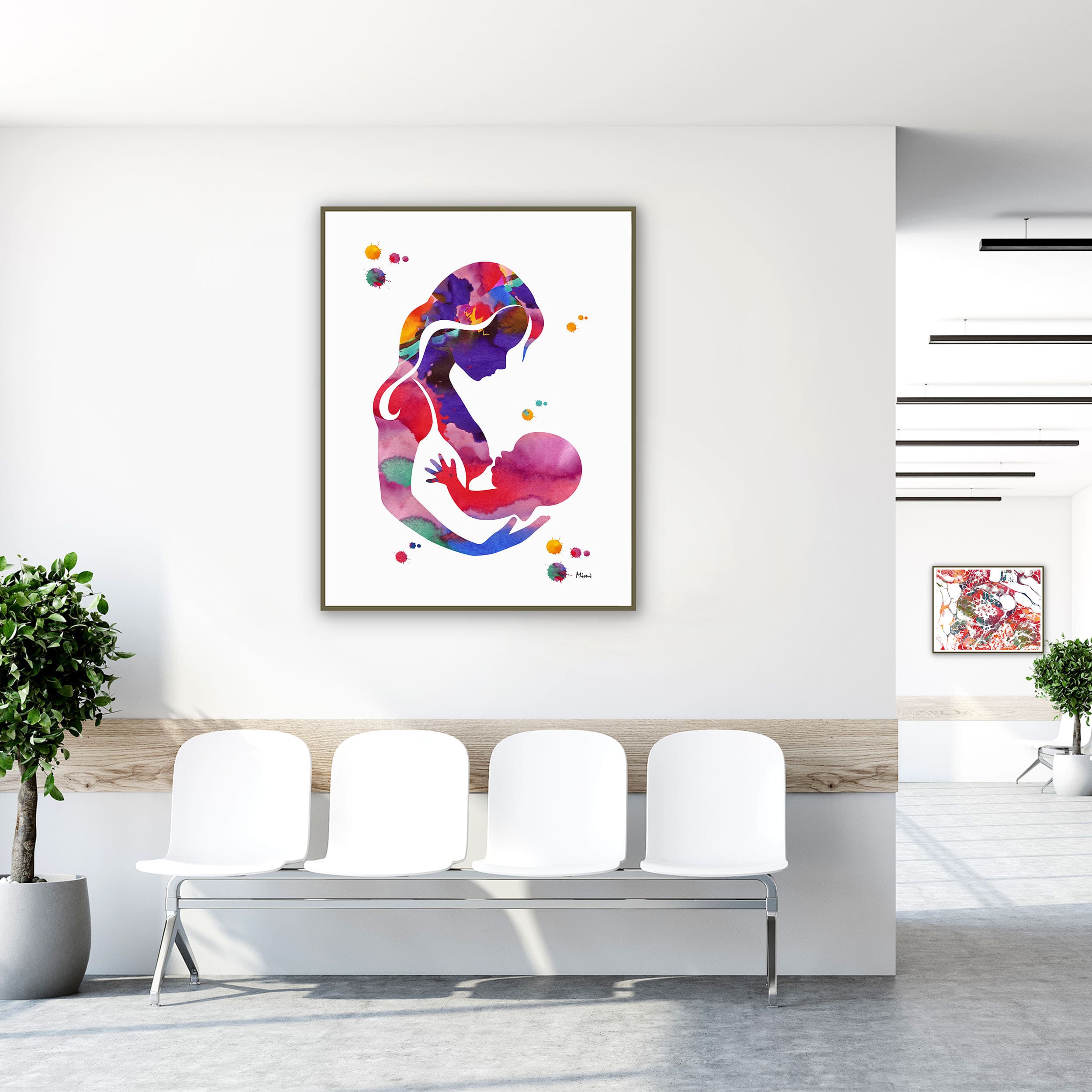 Framed breastfeeding mother & baby watercolor print in a clinic waiting room