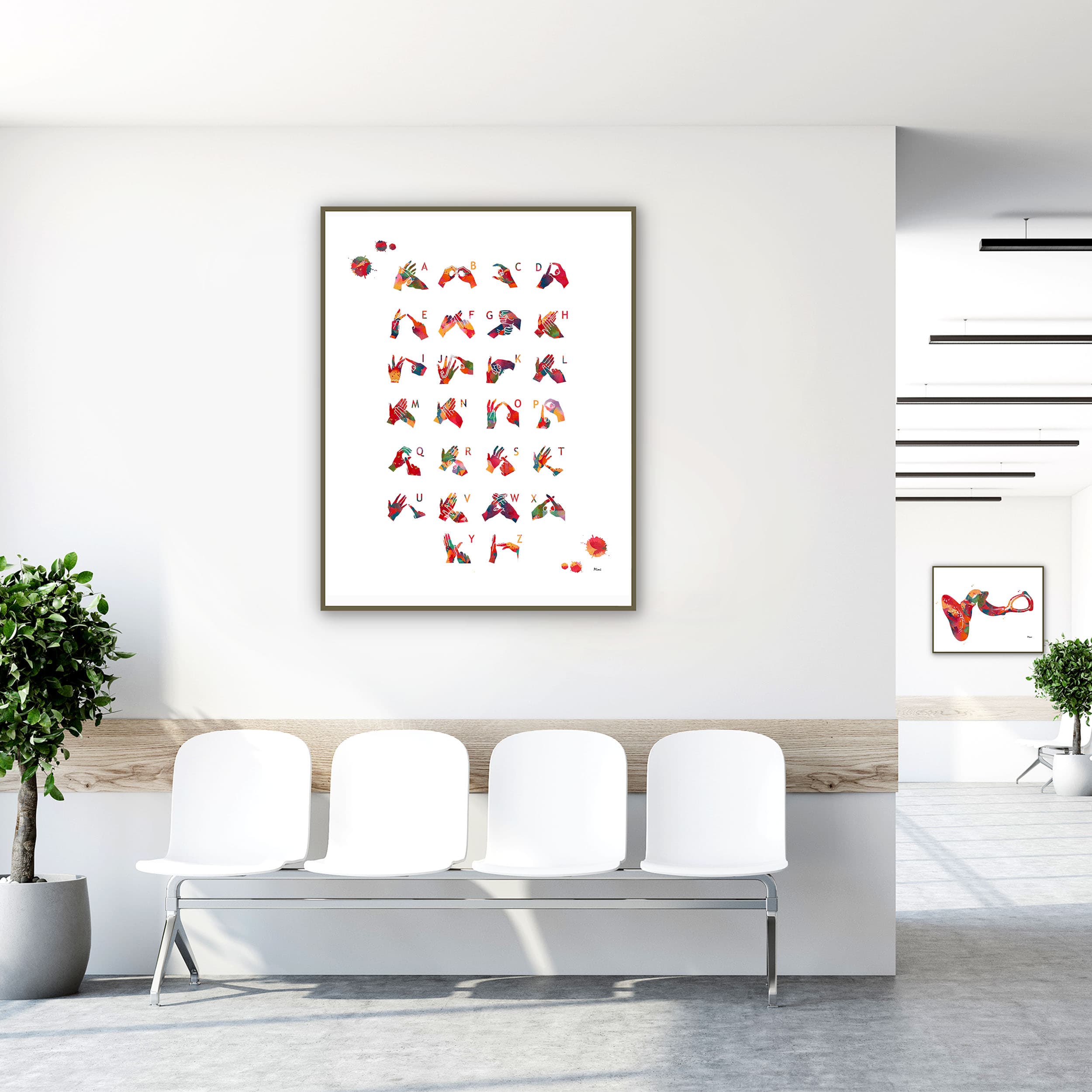 Framed bsl alphabet watercolor print in a clinic waiting room