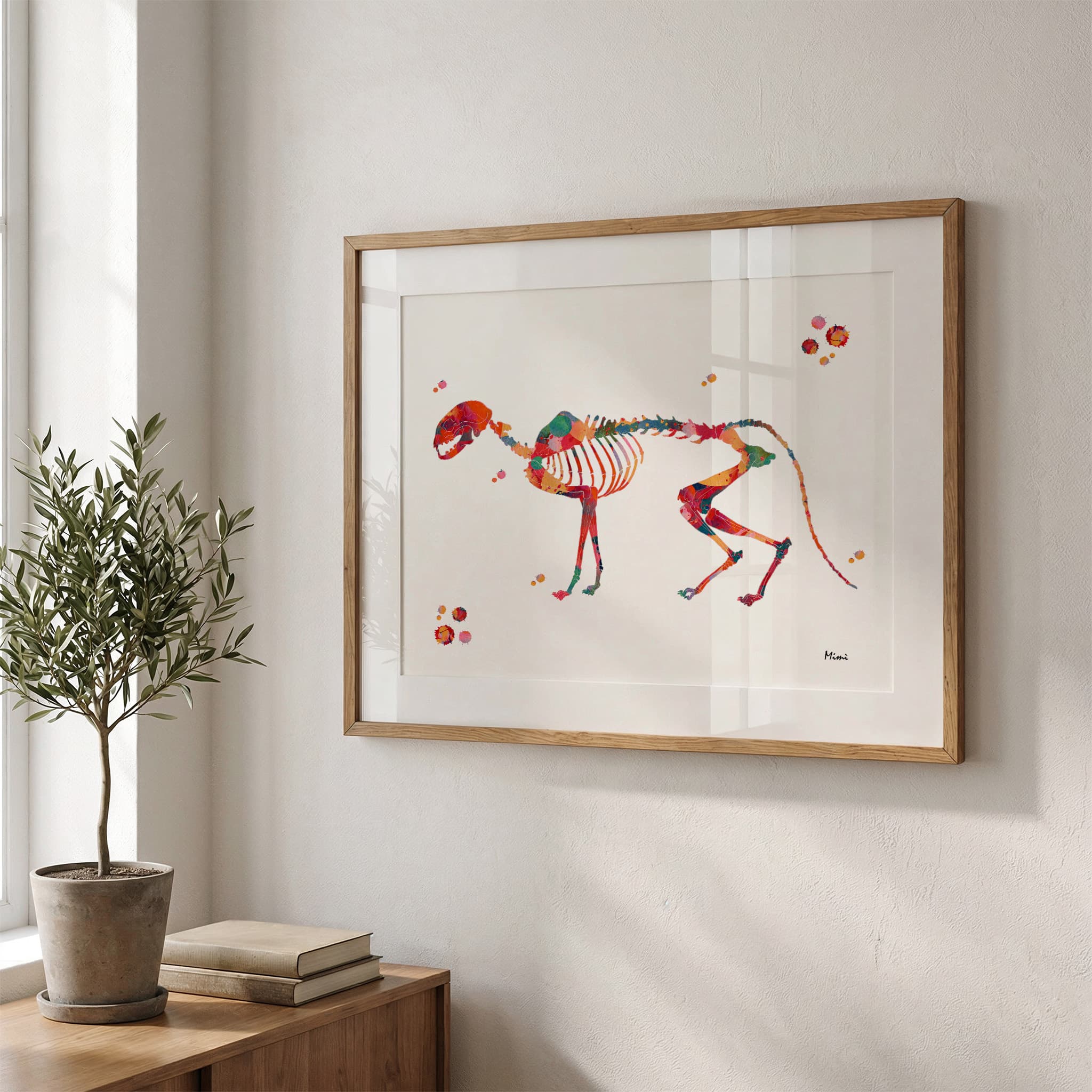 Framed cat skeleton watercolor print in a warm living room