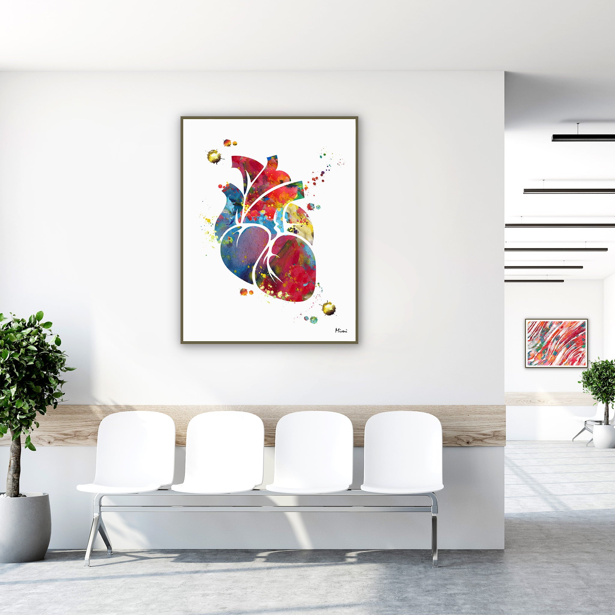 Framed colorful anatomical heart watercolor print in a clinic waiting room