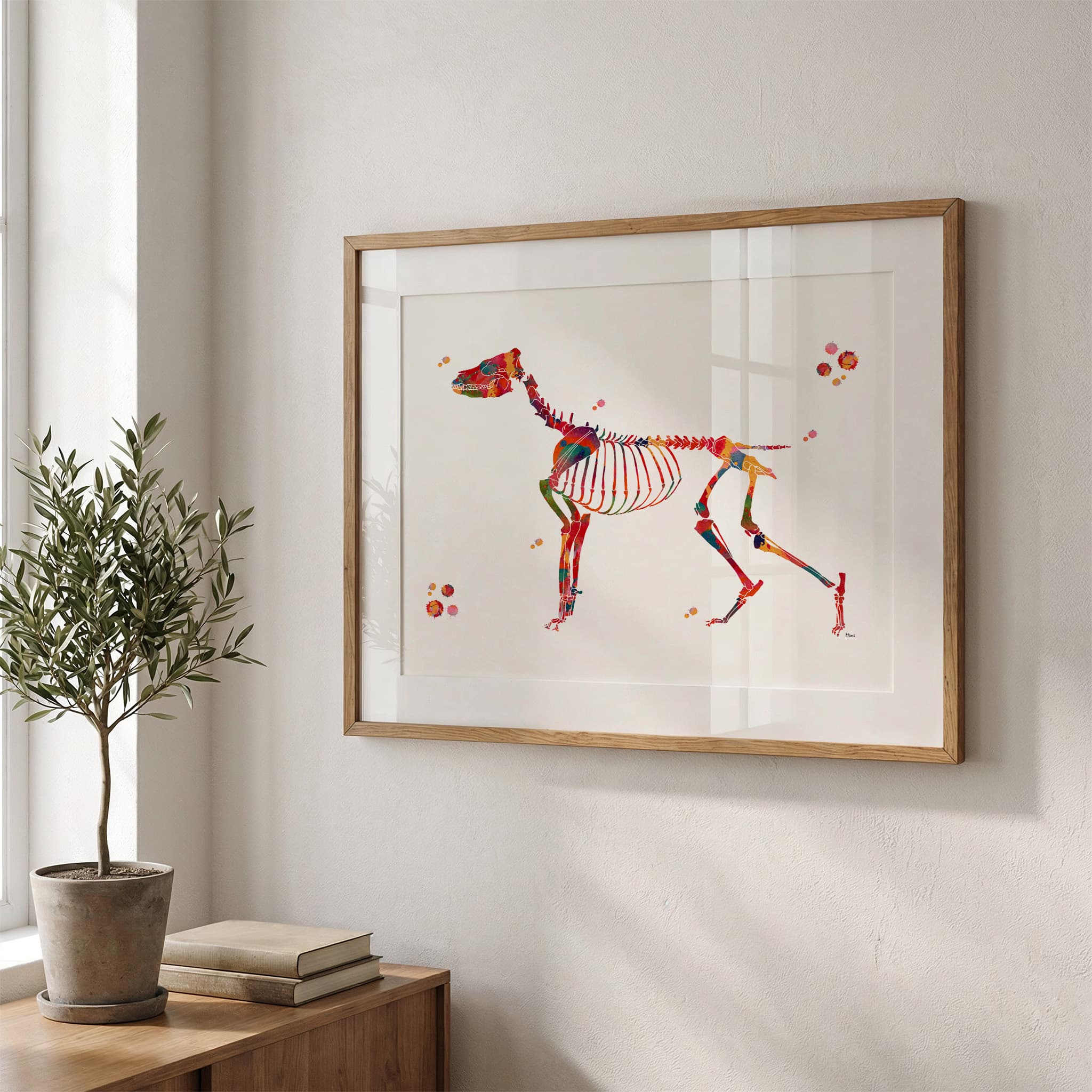Framed dog skeleton watercolor print in a warm living room