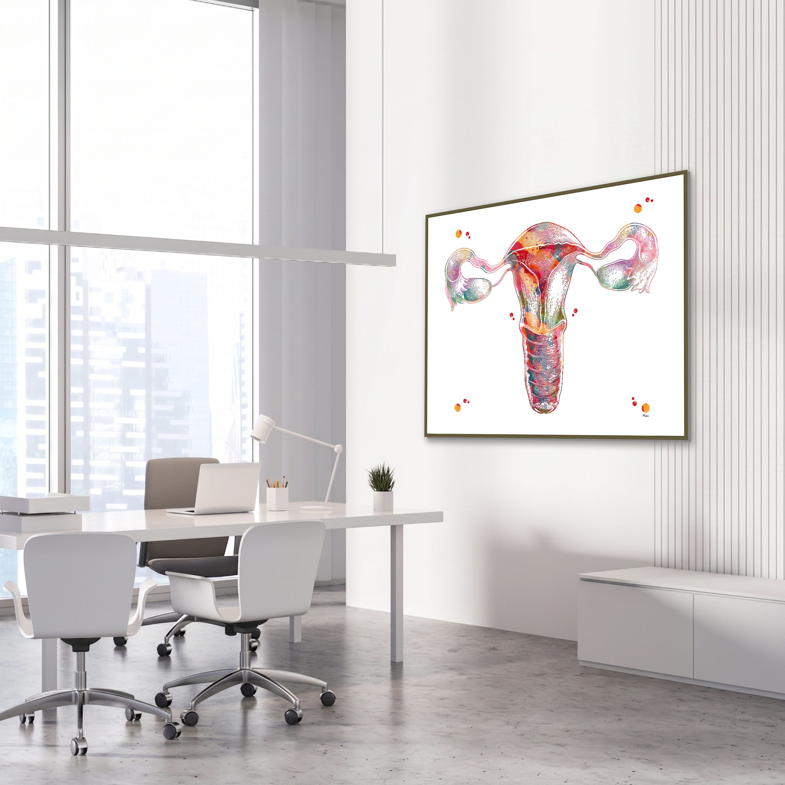 Framed female reproductive system anatomy watercolor print in an OB-GYN clinic