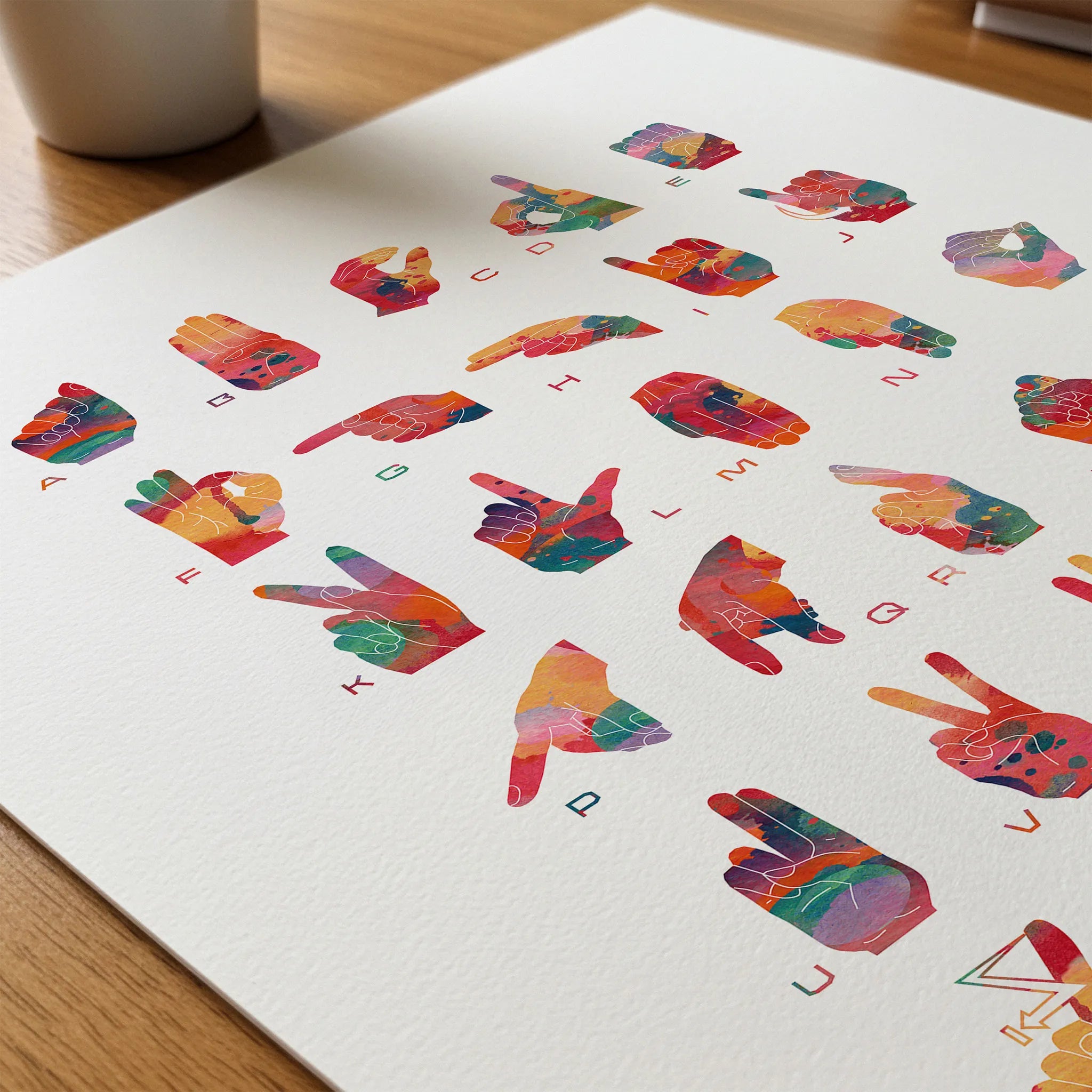 Close-up of german fingerspelling alphabet watercolor print showing paper texture and grain