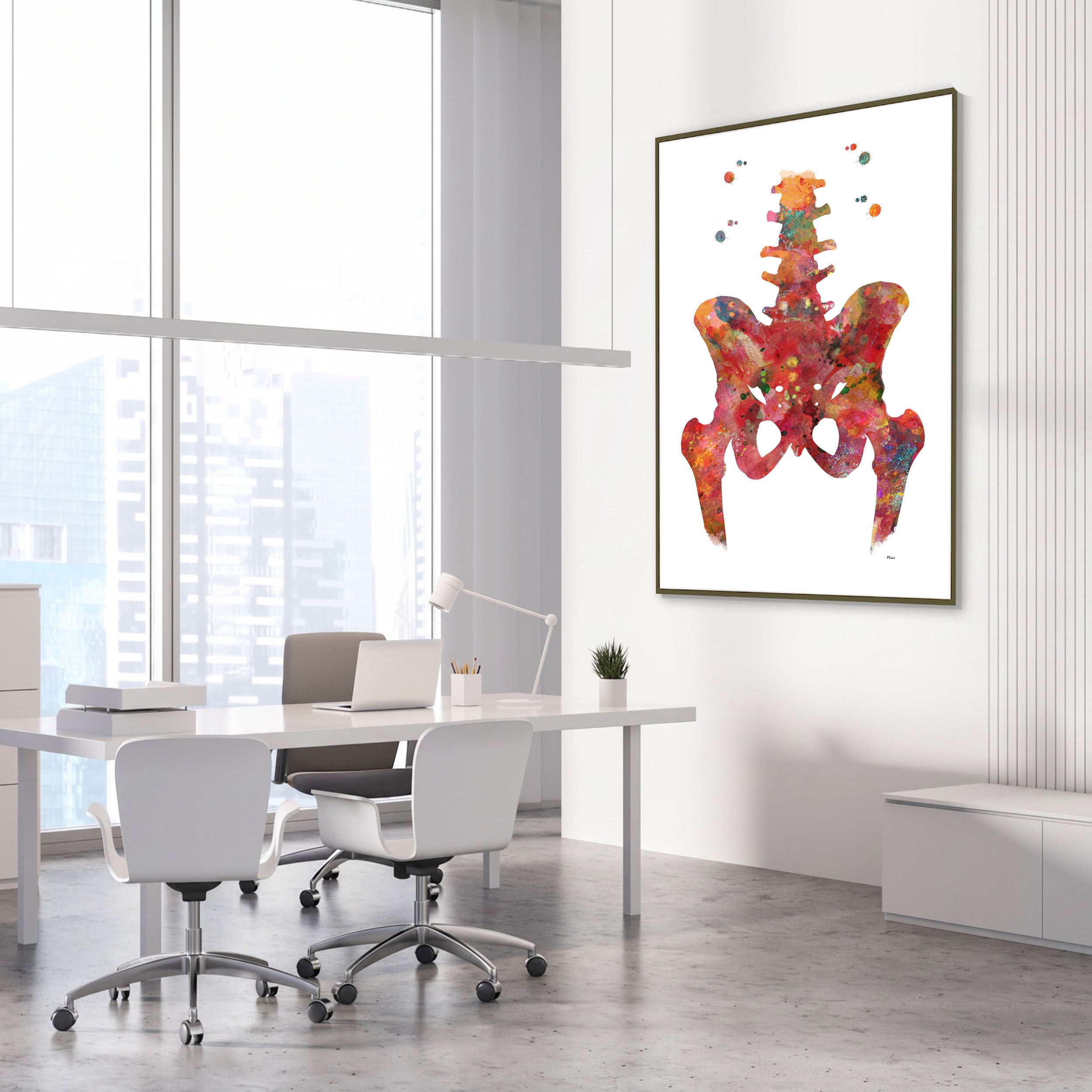 Framed hip & lower spine watercolor print in an orthopedic clinic