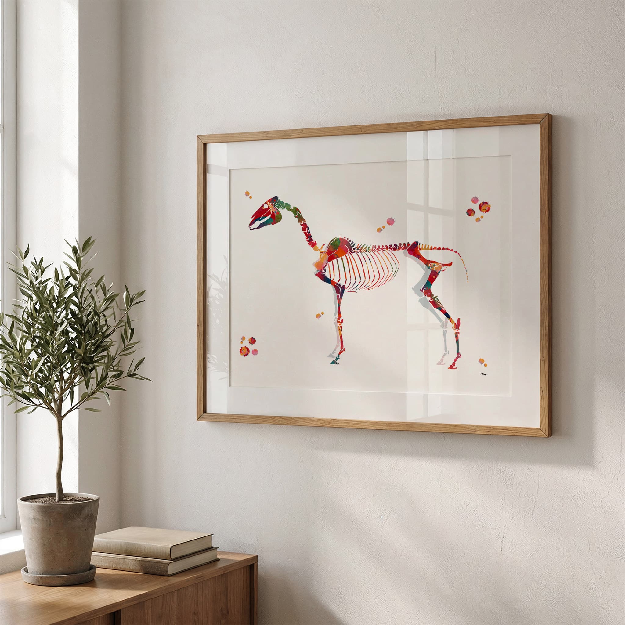 Framed horse skeleton watercolor print in a warm living room