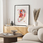 Framed human ear anatomy watercolor print in a warm living room