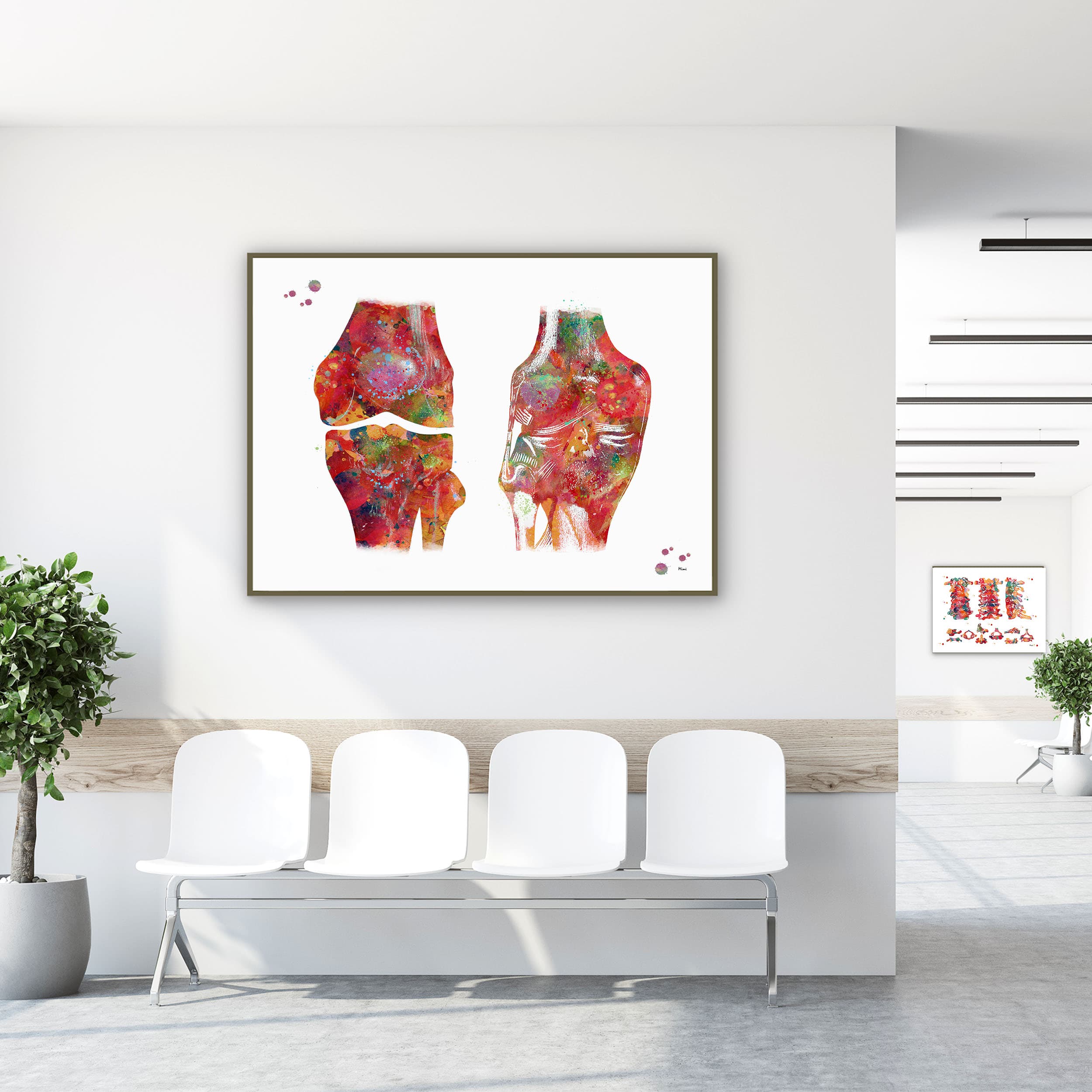 Framed human knee anatomy watercolor print in a clinic waiting room