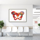 Framed human pelvis anatomy watercolor print in a clinic waiting room
