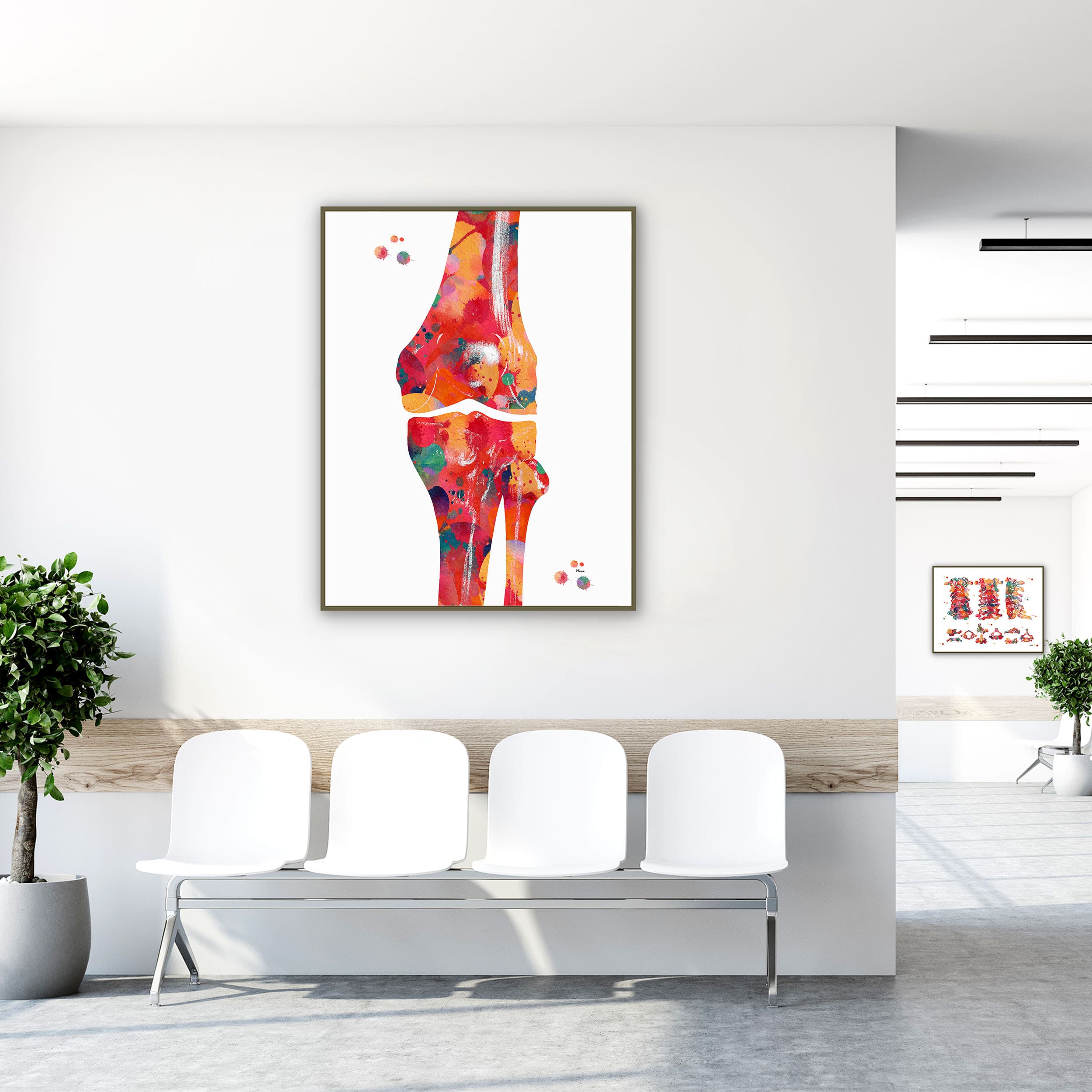 Framed knee bone anatomy watercolor print in a clinic waiting room