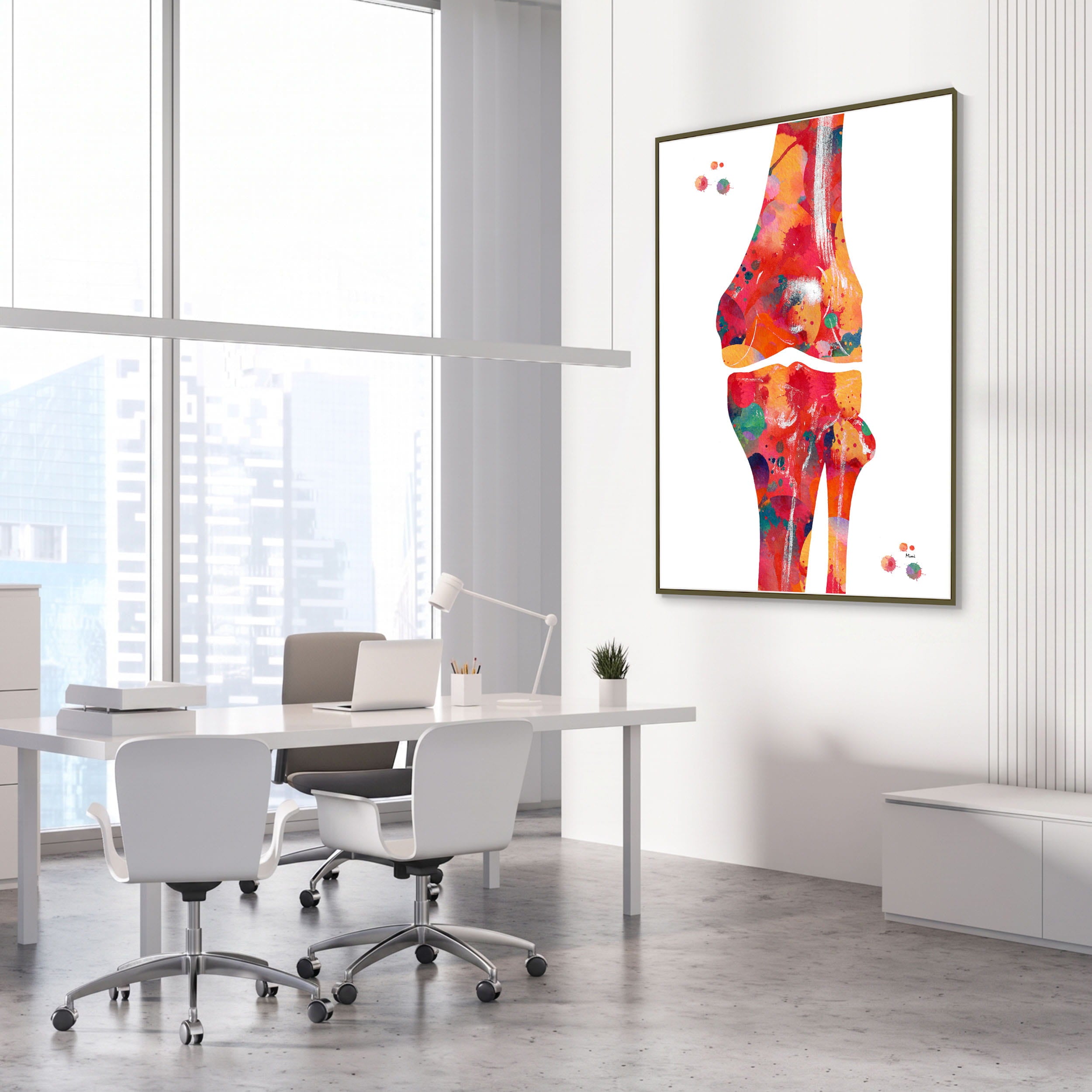 Framed knee bone anatomy watercolor print in an orthopedic clinic