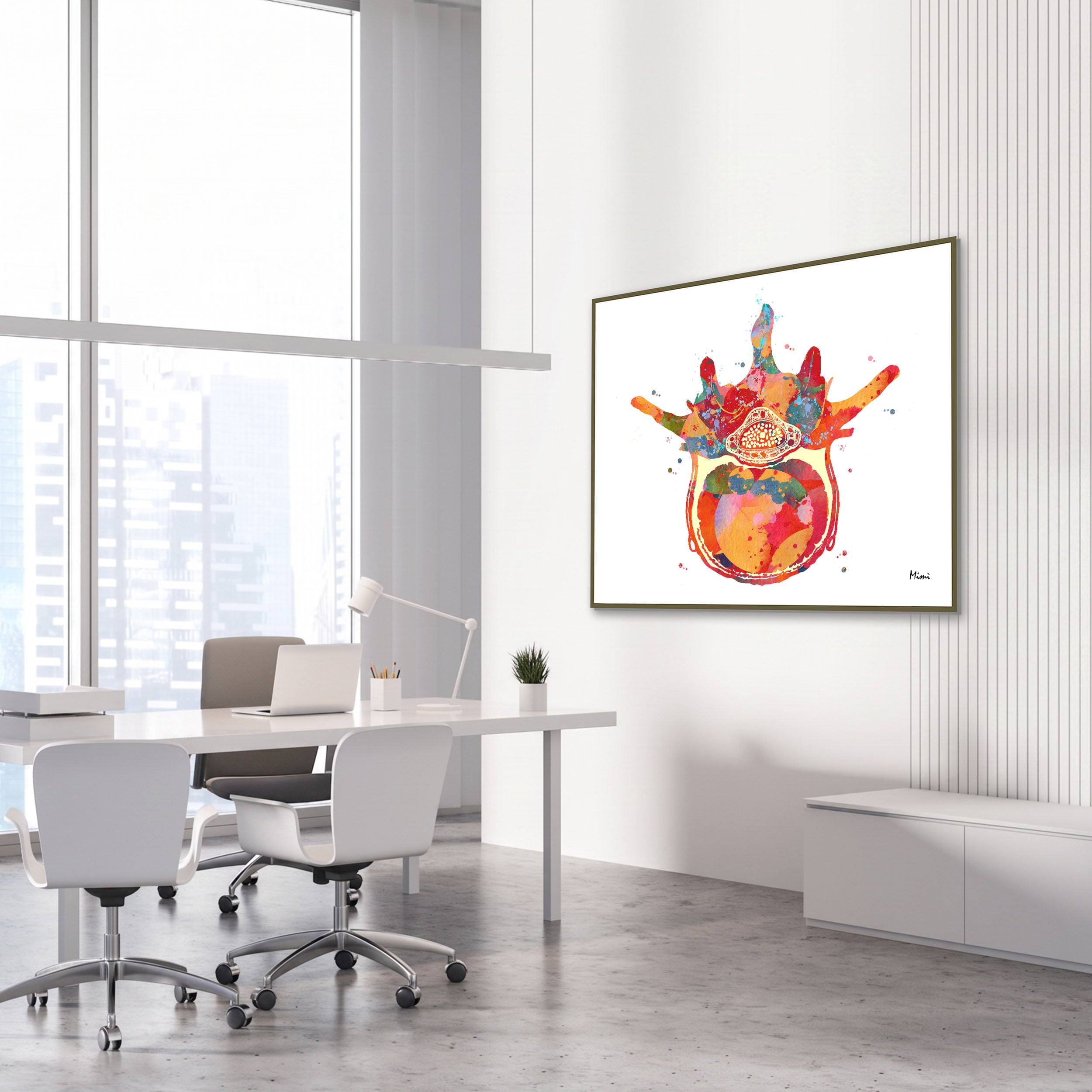 Framed lumbar vertebra anatomy watercolor print in an orthopedic clinic
