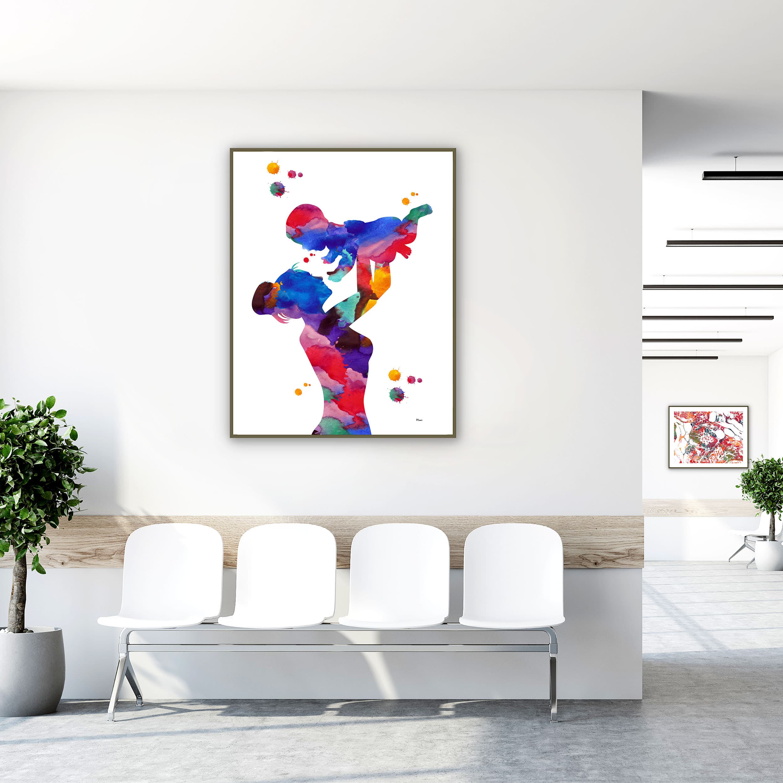 Framed mother holding her child watercolor print in a clinic waiting room