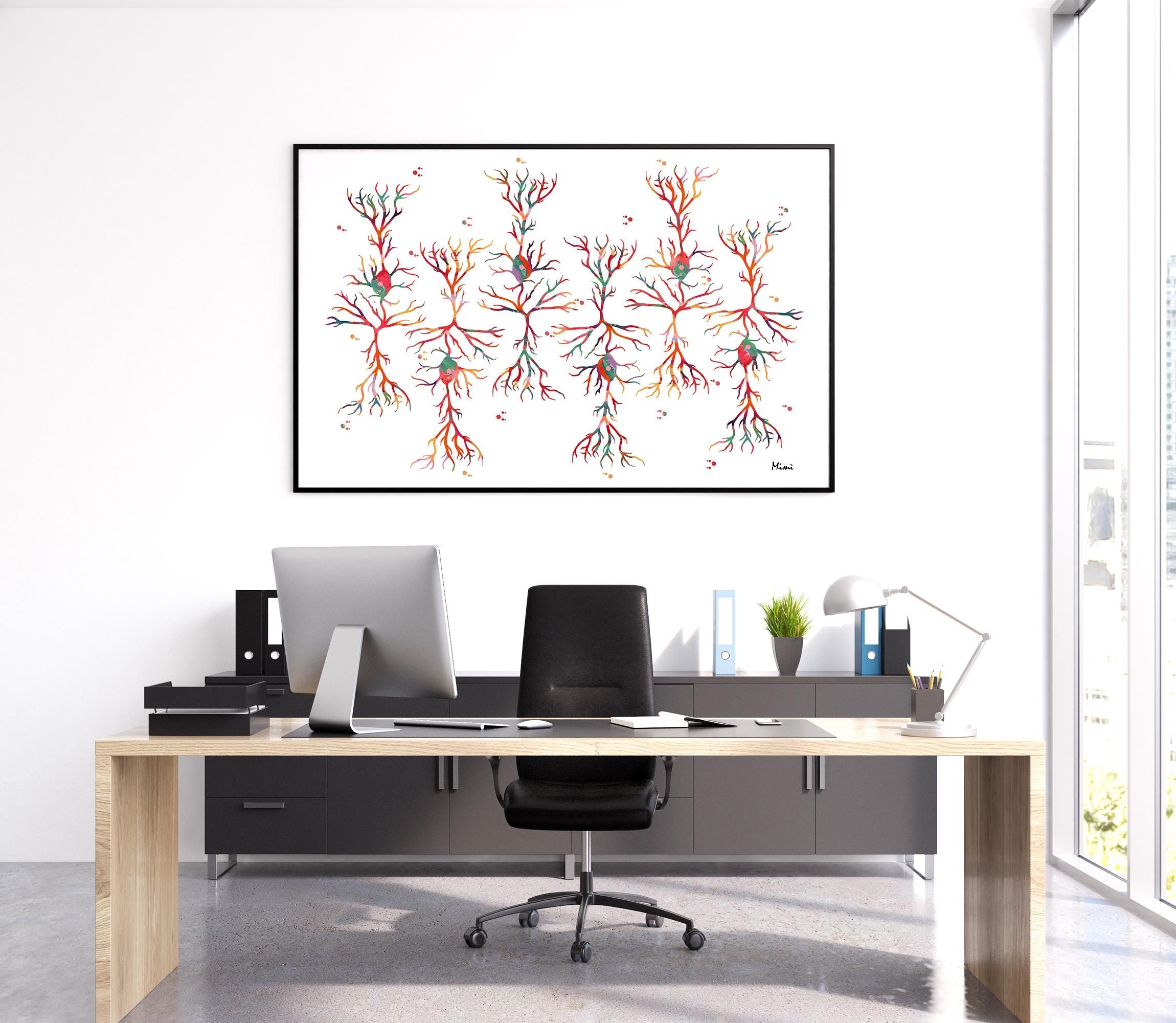 Modern office desk with computer setup and a framed watercolor print of neurons on the wall.