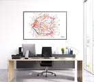 Modern doctor office desk with computer setup and colorful eye anatomy art on the wall.