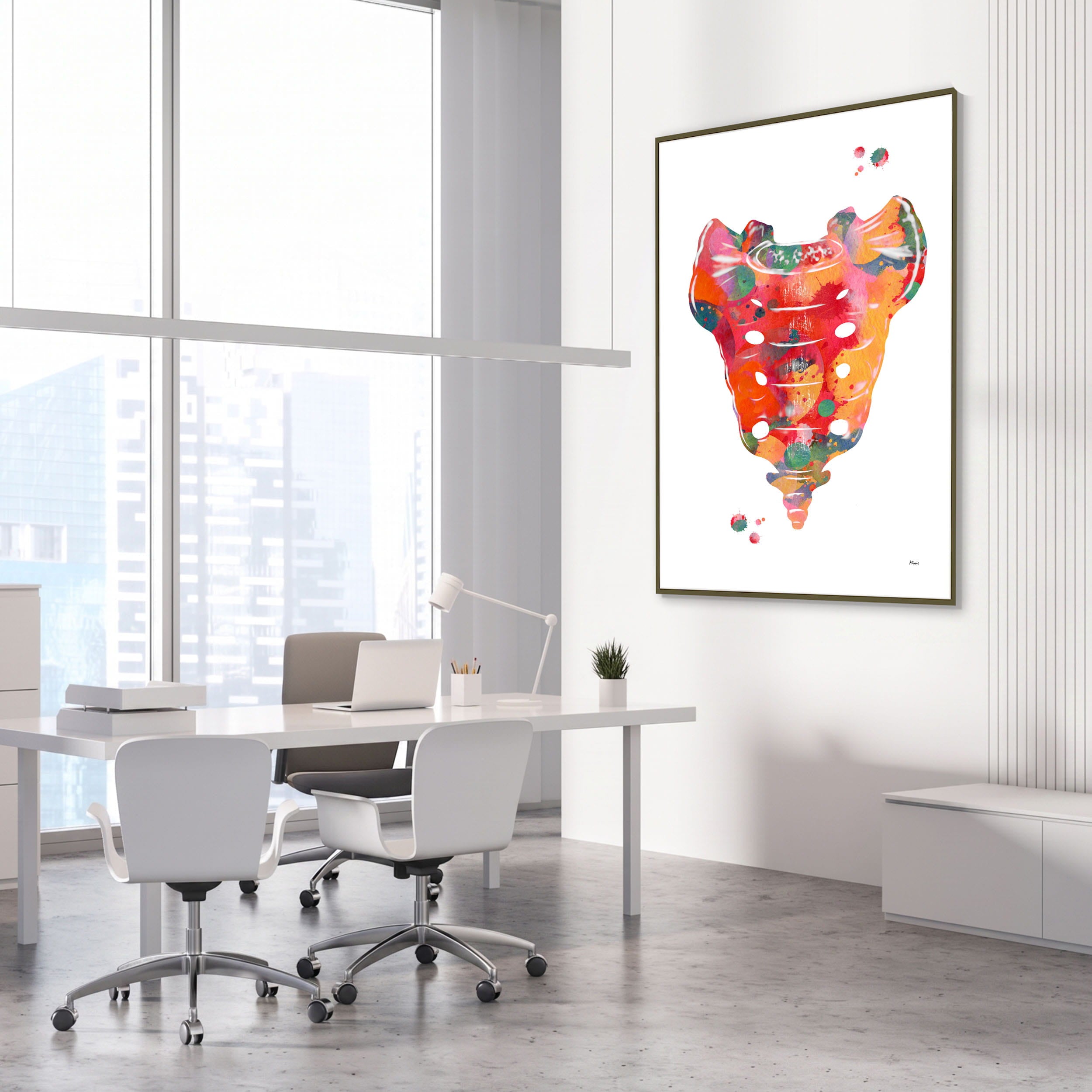 Framed sacrum bone anatomy watercolor print in an orthopedic clinic