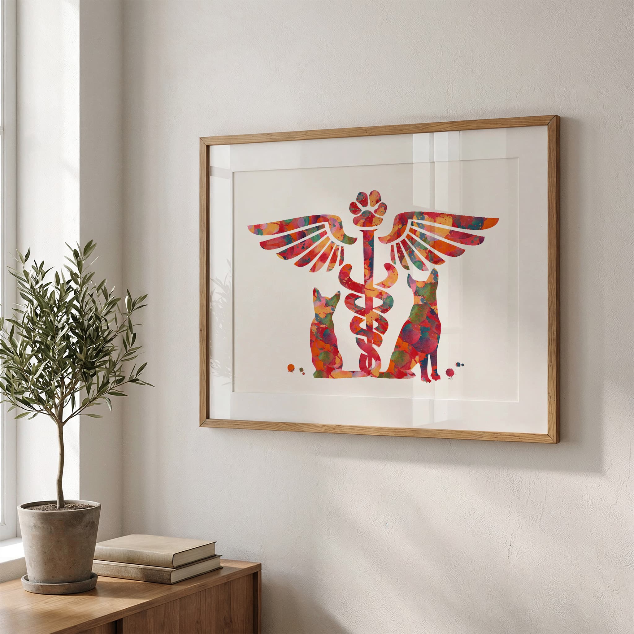 Framed vet caduceus cat & dog watercolor print in a warm living room