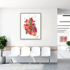 Framed vibrant abstract anatomical heart watercolor print in a clinic waiting room