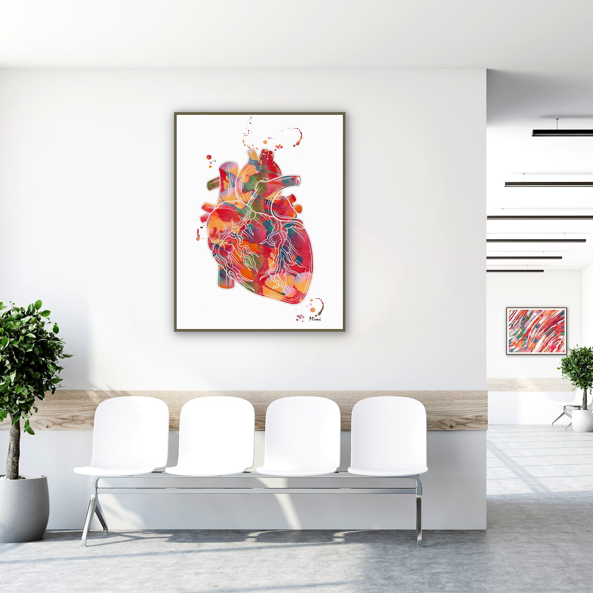 Framed vibrant abstract anatomical heart watercolor print in a clinic waiting room